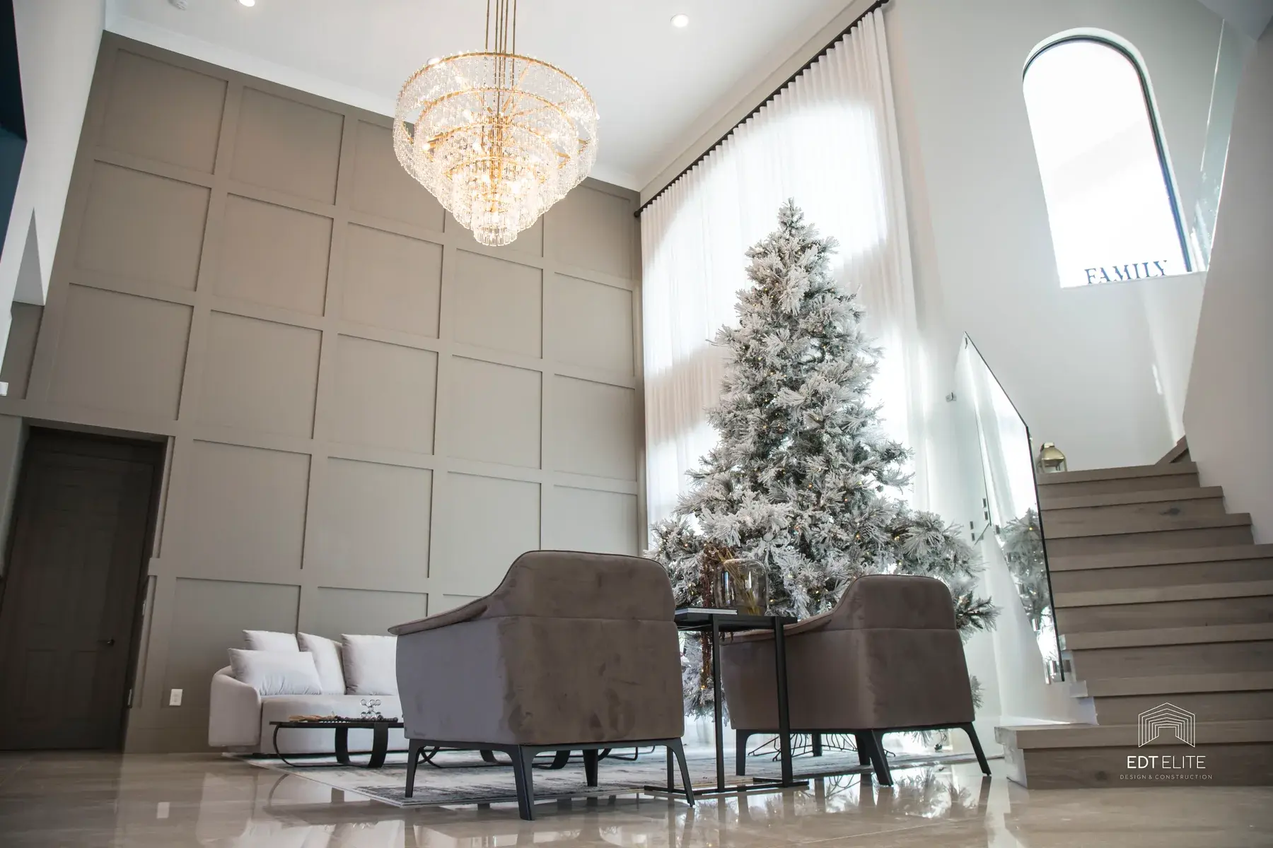 Living salon in the Delray Beach residence with layered neutral seating and natural light