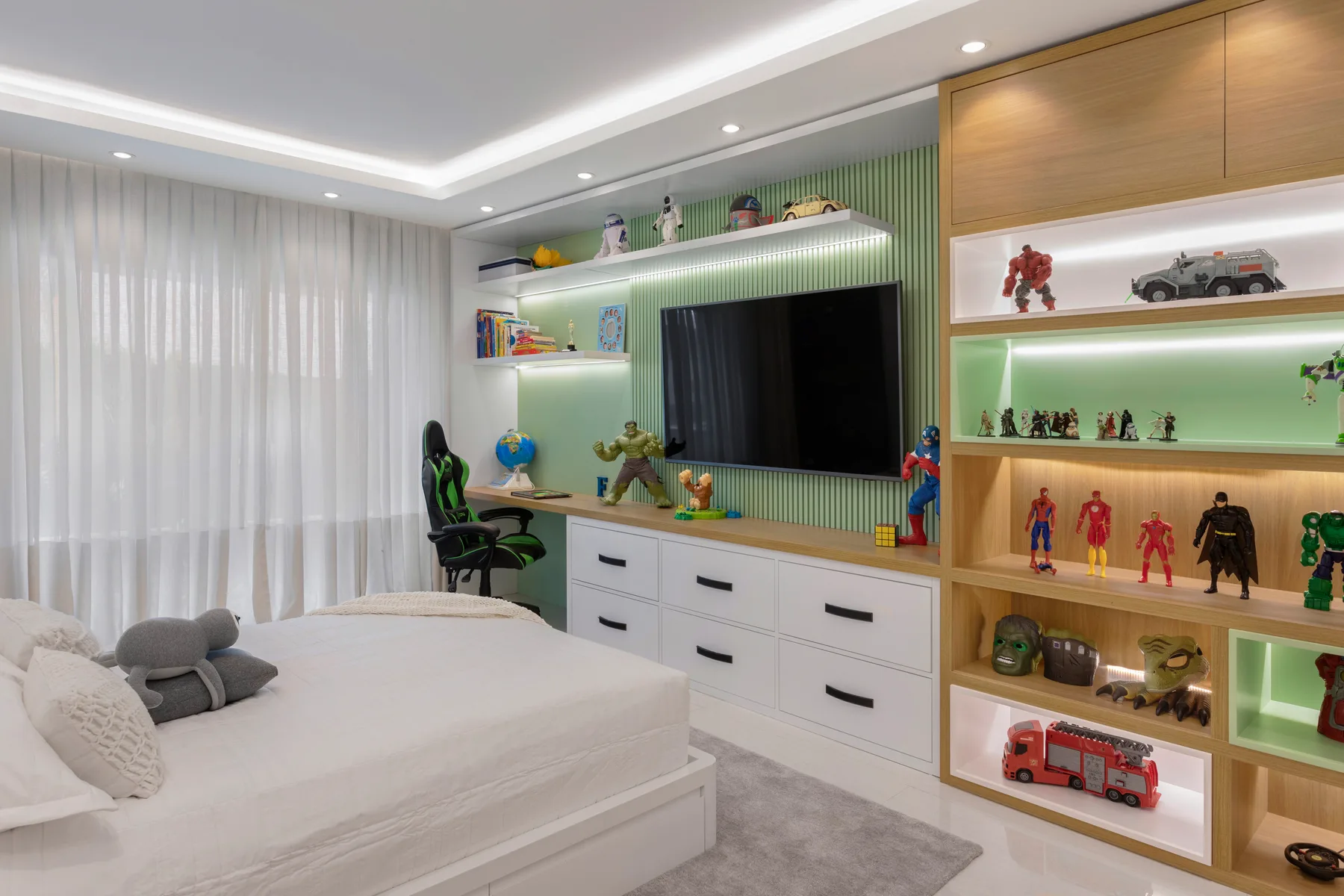 HOME IT bedroom with a green illuminated media wall, display shelving and custom drawers