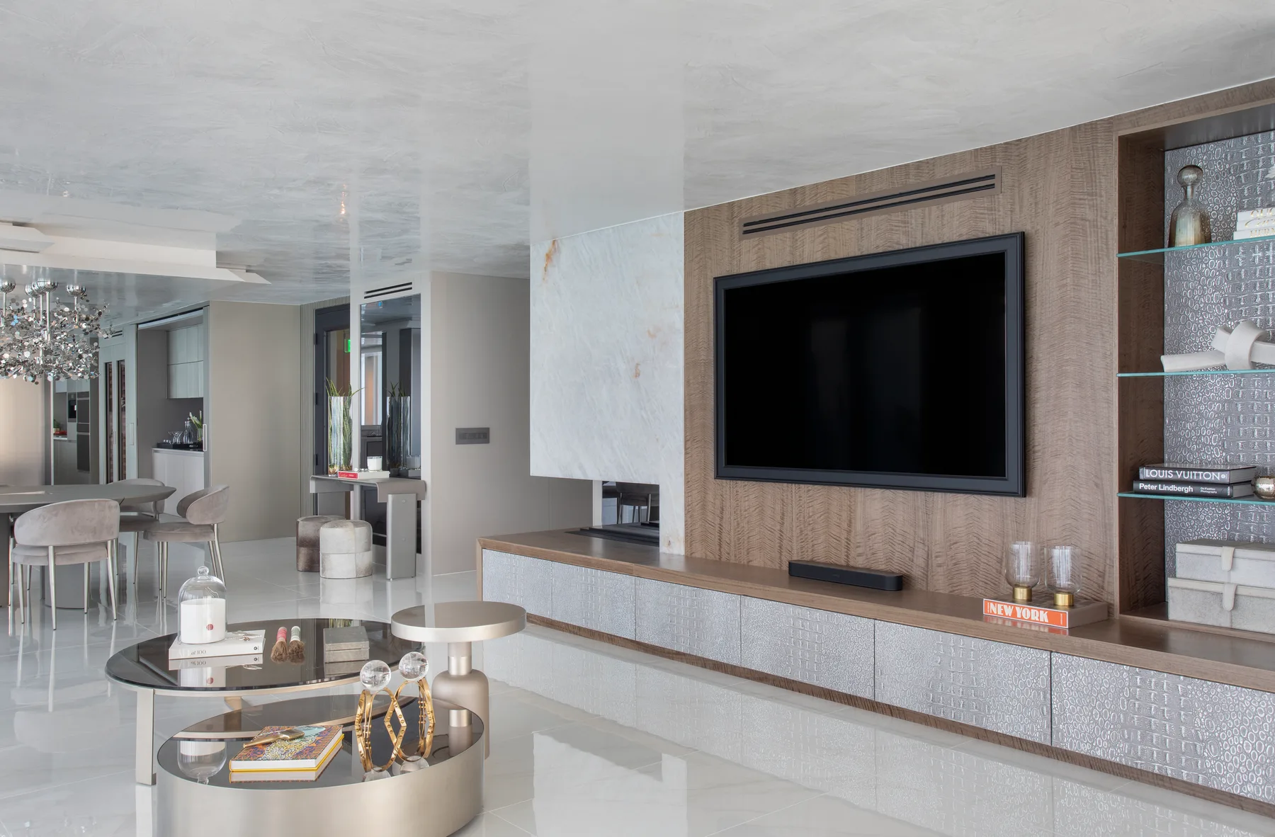 Media wall with custom shelving, an integrated TV and a fireplace
