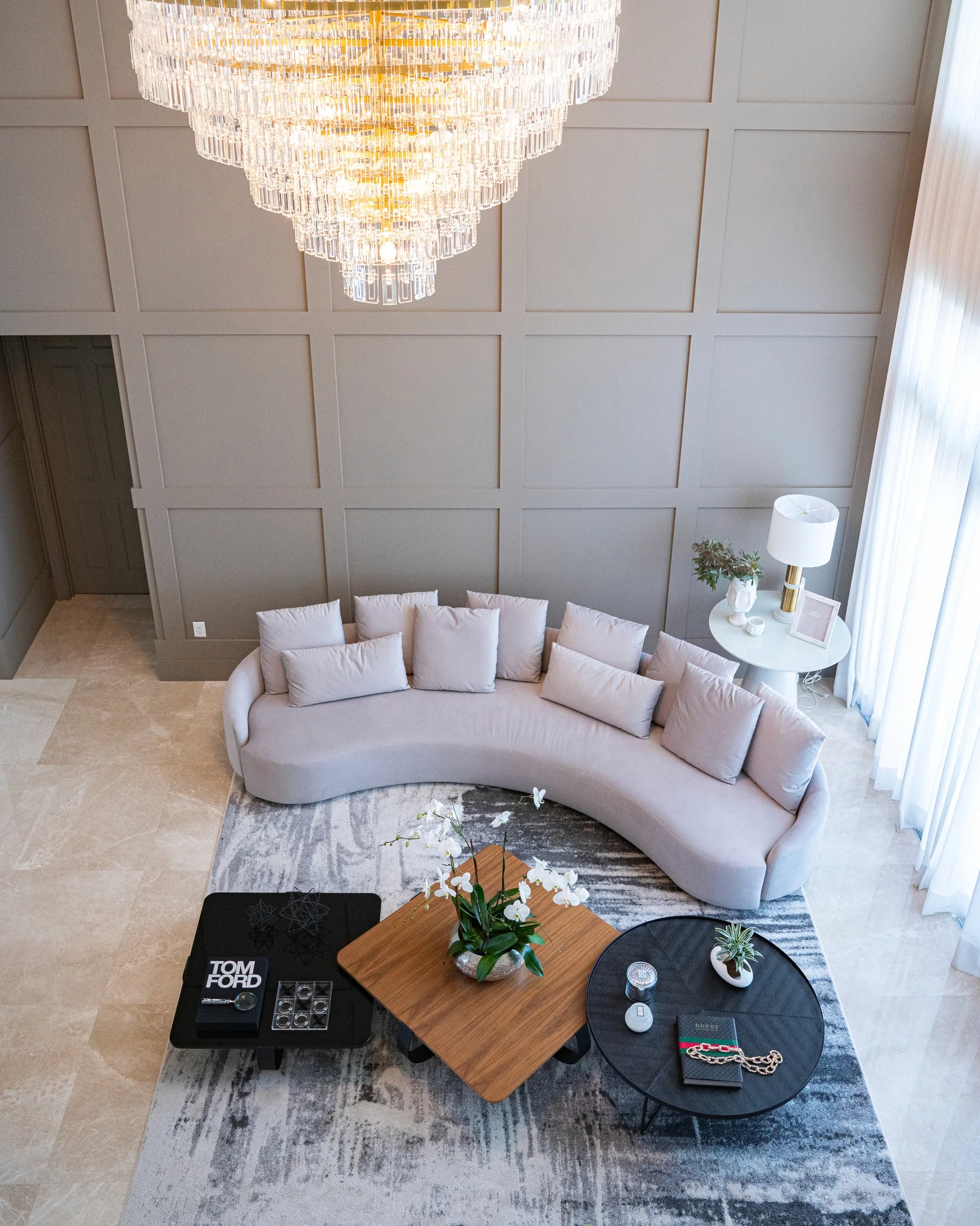 Living room with a curved blush sectional and textured wall panels