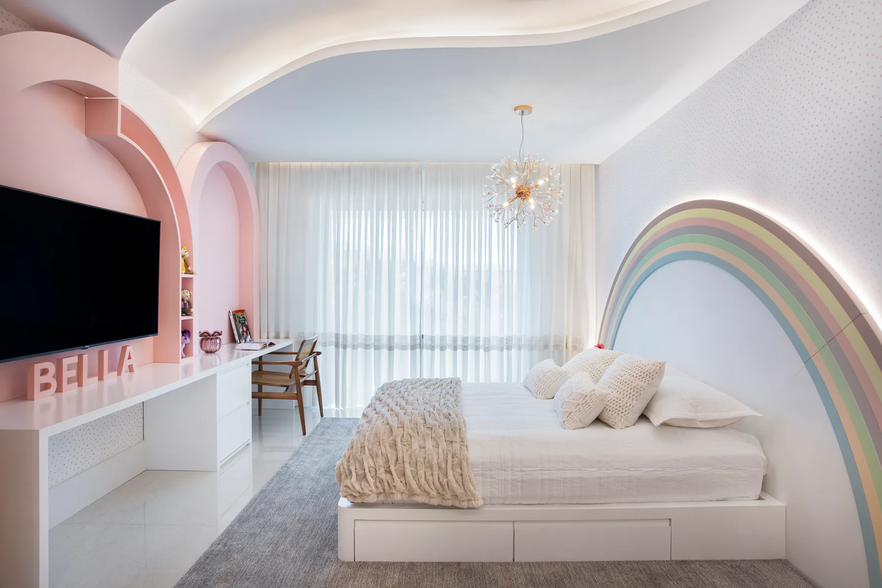 Primary bedroom with a channel-tufted headboard, crystal chandelier and bench seating