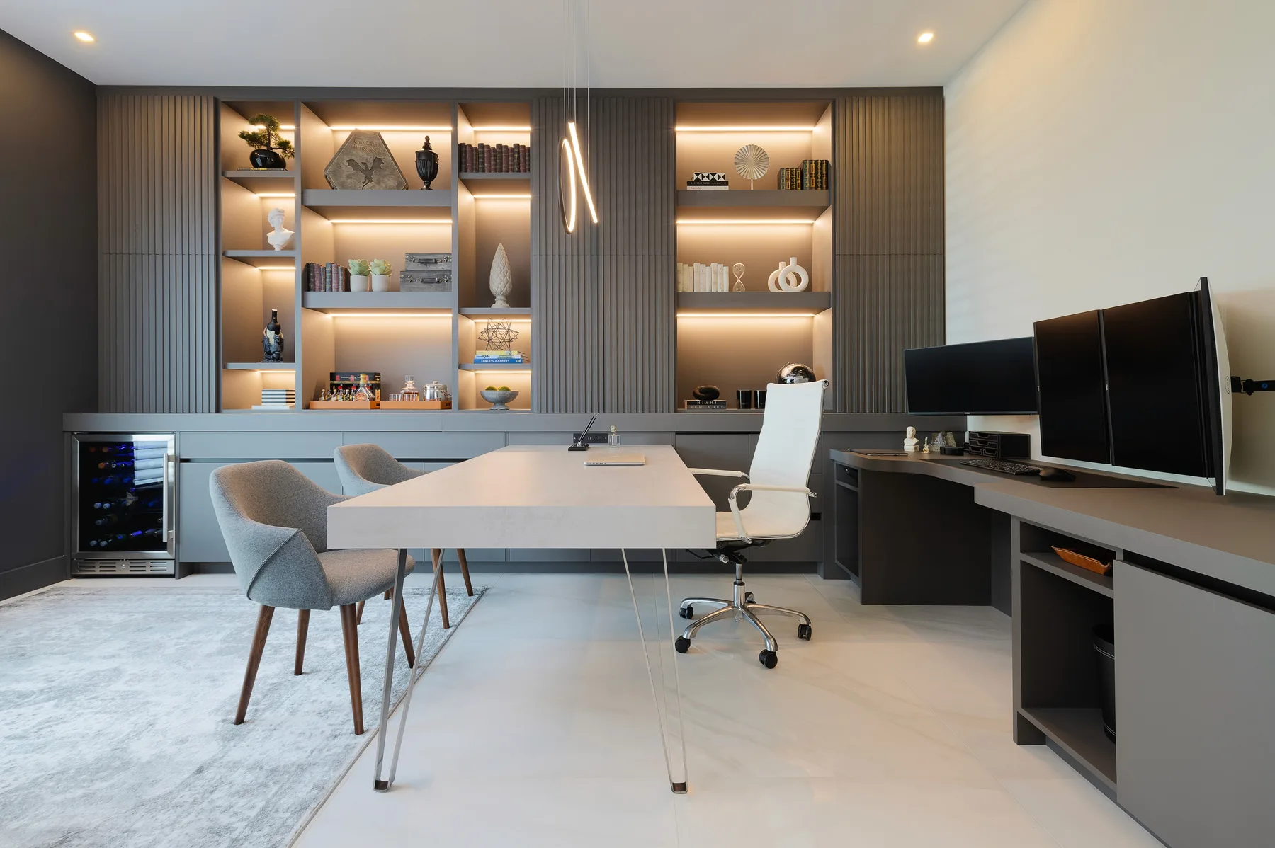 HOME DR office with a full wall of fluted cabinetry, open shelves, drawers and integrated lighting