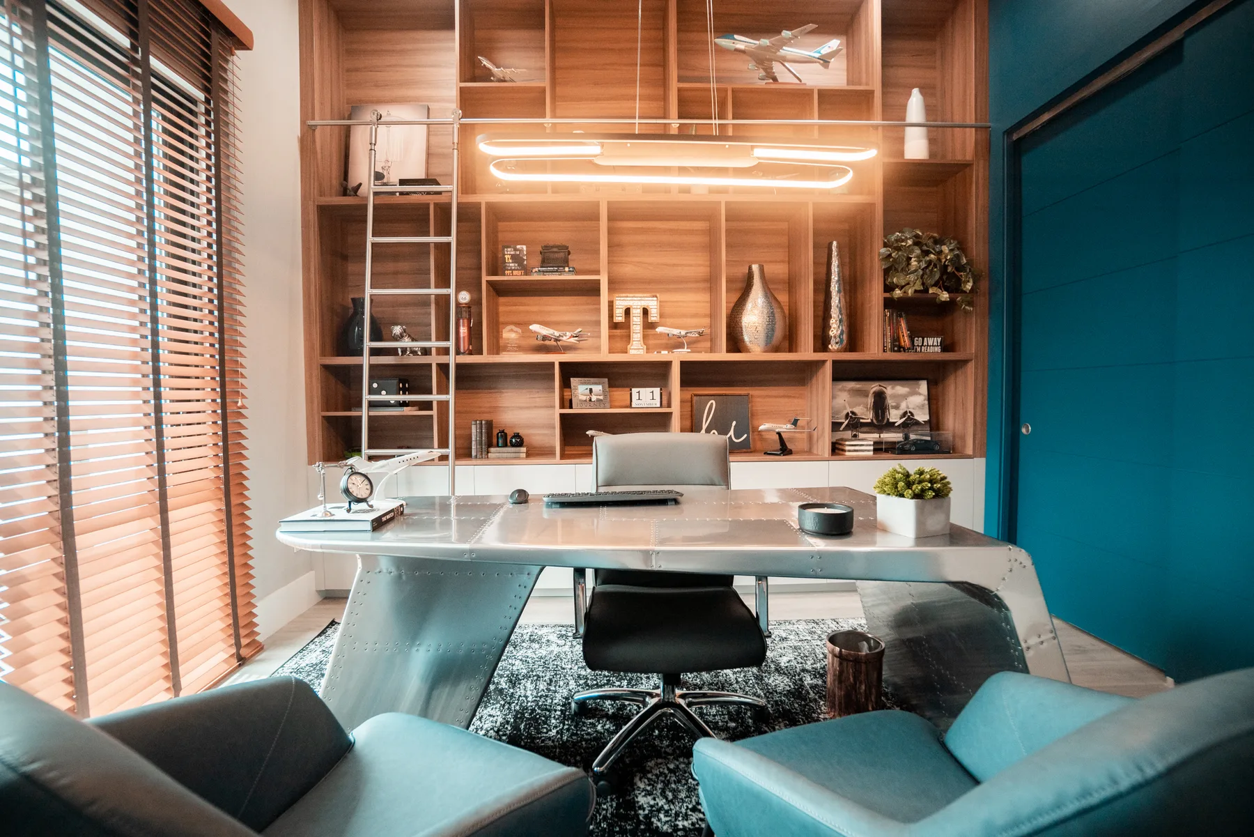 Game room with a billiards table and turquoise built-in shelving
