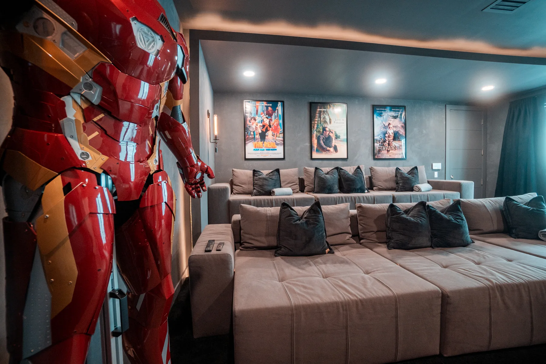 Home theater with a wide projection screen and collector's display figures