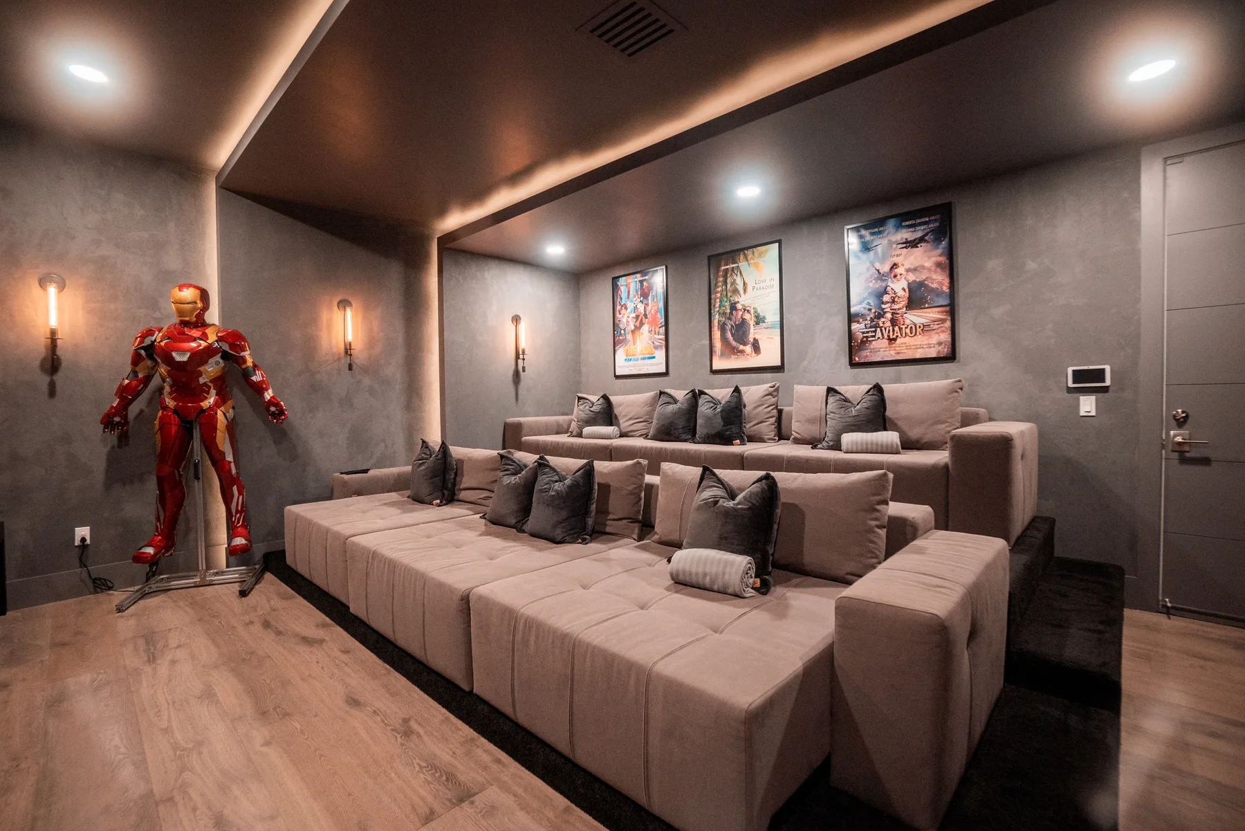Dark home theater with ambient cove lighting and a full-width screen