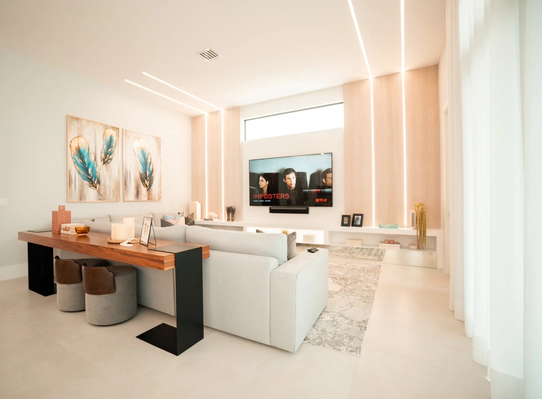 Game room with a billiards table, turquoise seating and a display wall